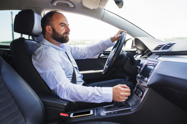 side-view-man-driving-car_23-2147841909